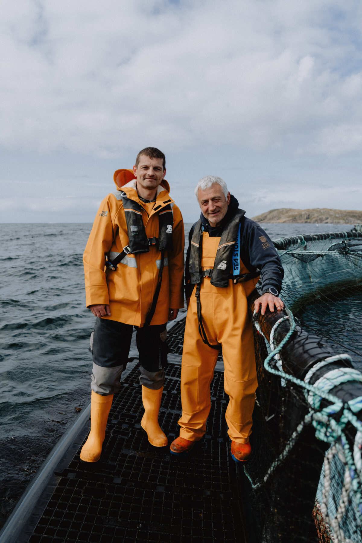 Two fish farm workers on site