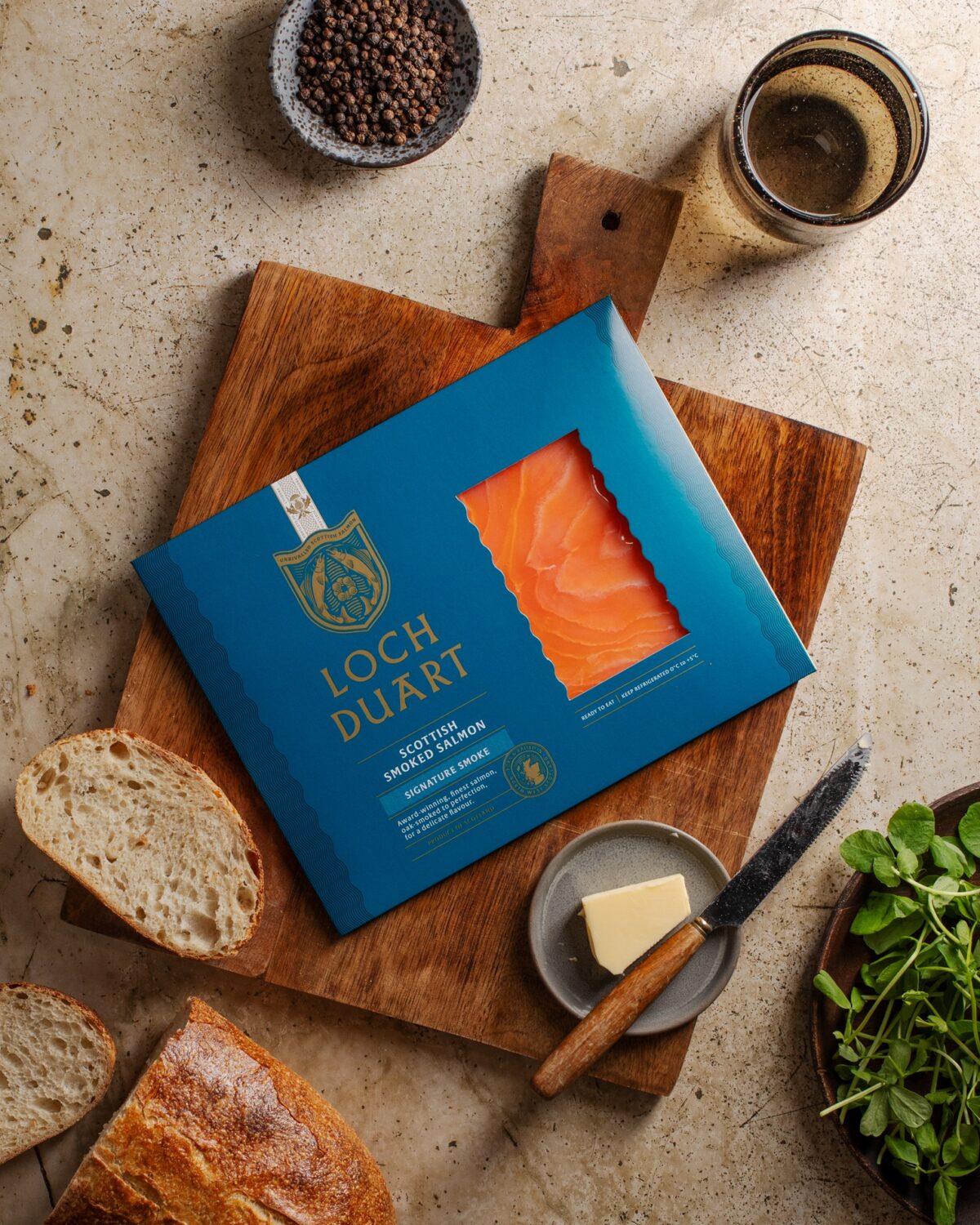 Pack of Loch Duart Signature Smoked Salmon on wooden board.